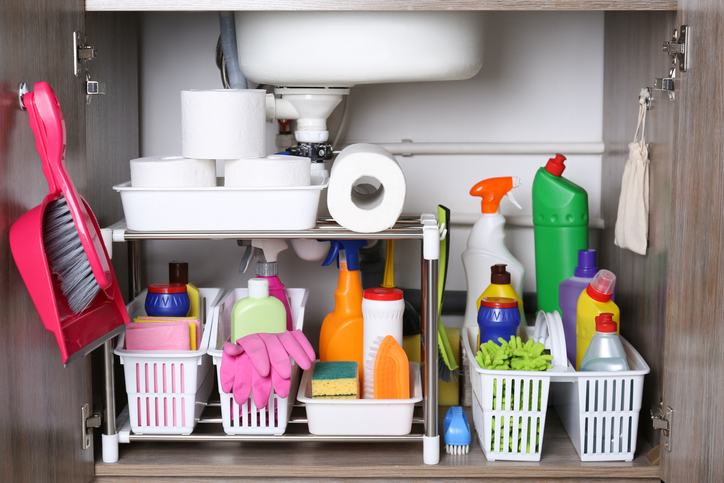 A shelf used for storing cleaning products in the workplace.