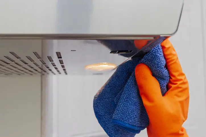 A professional cleaner regularly cleans the hood ranges of commercial kitchens to ensure better airflow, reduce smoke and odors, and prevent grease fires.