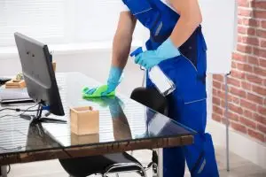 A cleaning expert using eco-friendly cleaning products as an advantage in commercial spaces.