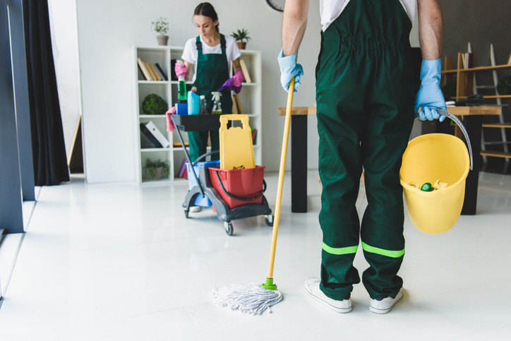Cleaners mopping the floor, highlighting the importance of cleanliness in business.