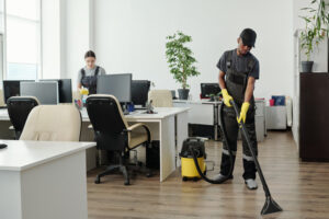A professional cleaner mopping high-traffic office floors, illustrating the labor and property size factors that determine how much does a commercial cleaning service cost.