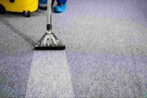 Commercial carpet cleaning service using professional extraction equipment to deep clean office carpet flooring.