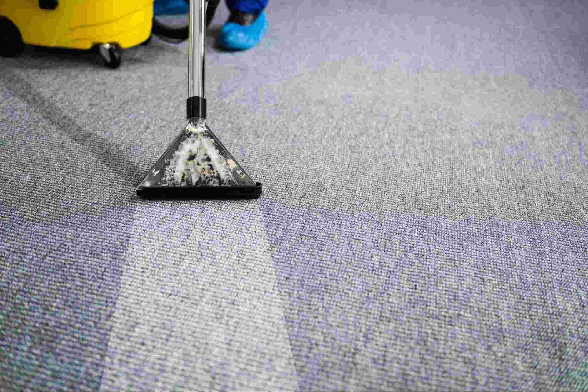 Commercial carpet cleaning service using professional extraction equipment to deep clean office carpet flooring.