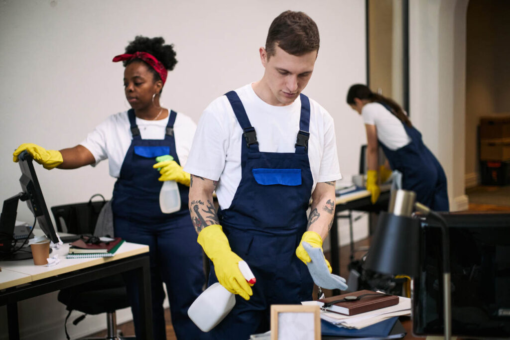 Commercial cleaning team working in an office showing how much office cleaning cost depends on workspace size, staff, and service scope.
