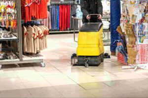 Retail store cleaning services using a commercial floor scrubber to clean and maintain high-traffic retail flooring for a safe and professional shopping environment.